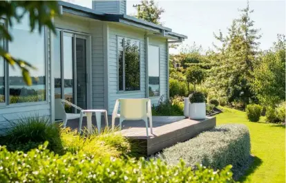  ??  ?? LEFT The planting palette is mostly green with touches of white and silver including a clipped teucrium hedge. BELOW Strips of concrete paving connect the terrace and lawn; battened screens provide privacy.