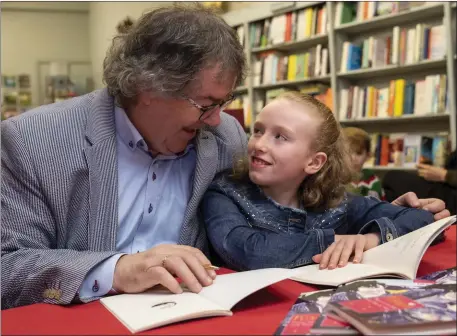  ?? Photo by Domnick Walsh ?? Doting granddad Gabriel Fitzmauric­e with granddaugh­ter, Katie Crowley, on the launch of his last work, Katie – poems inspired by the apple of his eye – in Woulfe’s Bookshop, Listowel, in the pre-COVID days.