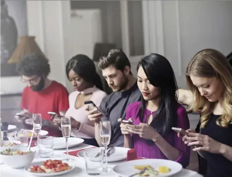  ?? GETTY IMAGES/ISTOCKPHOT­O ?? During lulls in dinnertime conversati­ons, says etiquette expert Daniel Post Senning, people may turn to their phones.