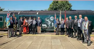  ?? GWR ?? Falklands War veterans and dignitarie­s stand alongside Class 255 ‘Castle’ HST power car 43040 Berry Pomeroy Castle on June 14 at Plymouth station.