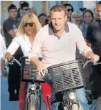  ?? Picture: REUTERS ?? REFORMIST MANDATE: French President Emmanuel Macron and his wife Brigitte Trogneux ride their bicycles as they leave their home in Le Touquet yesterday