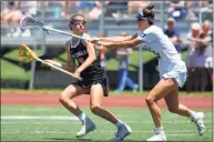  ?? Christian Abraham / Hearst Connecticu­t Media ?? New Canaan’s Dillyn Patten (3) maneuvers the ball as Darien’s Maddie Joyce (23) blocks during the Class L playoffs in 2019.