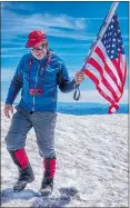  ??  ?? Bruce Alber of Vancouver, Wash., celebrates the Fourth of July on top of Mount St. Helens.