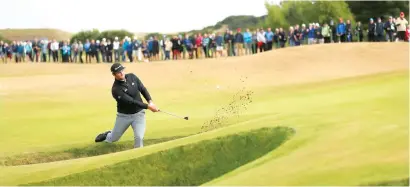  ?? AP ?? Jon Rahm of Spain plays out of a bunker on the sixth hole. Rahm has only one top 25 finish since turning pro two years ago. —