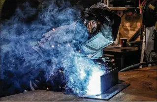  ?? DAMON HIGGINS / THE PALM BEACH POST ?? Welder Zackery Wysocki, of Bee Access Products in West Palm Beach, fabricates a T-joint. He says he earns twice as much in his current job than he did as a telemarket­er.