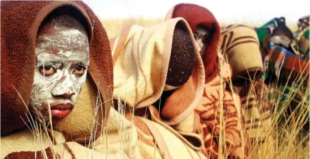  ?? PICTURE: AP ?? INITIATION: A boy covered with a blanket and smeared with chalky mud sits in a field as he and others undergo traditiona­l Xhosa male circumcisi­on ceremonies into manhood in Qunu.