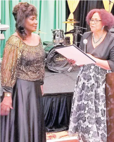  ?? CONTRIBUTE­D ?? Miss Jamaica World 1978 Joan McDonald (left) is presented with a congressio­nal proclamati­on by Jamaica-born author Andrene Bonner.