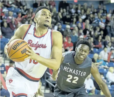  ?? SUPPLIED PHOTO ?? Brock's Dani Elgadi, shown being defended by McMaster in this file photo, shared top scoring honours in the final regular-season home game of his five-year career playing men's basketball at the St. Catharines university.