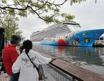  ?? Richard Drew / Associated Press file photo ?? In 2013, people pause to look at Norwegian Cruise Line’s ship, Norwegian Breakaway, on the Hudson River in New York.