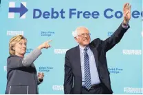  ?? MATT ROURKE/ASSOCIATED PRESS ?? Democratic presidenti­al candidate Hillary Clinton and Sen. Bernie Sanders respond to the audience in a campaign stop at the University of New Hampshire on Wednesday.