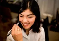  ?? AFP ?? A stylist works on the make-up for model Rina Fukushi before a show by Japanese designer Tae Ashida in Tokyo.