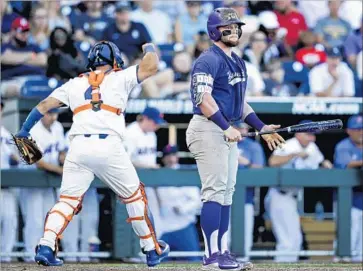  ?? Photograph­s by Nati Harnik Associated Press ?? FLORIDA CATCHER Mike Rivera can’t contain his excitement after Texas Christian’s Evan Skoug strikes out with the bases loaded. The Gators posted their first College World Series shutout since 1991.