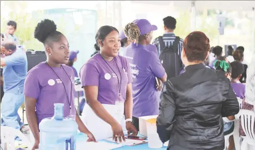  ?? (Photo by Terrence Thompson) ?? Health workers interactin­g with a member of the public during the launch of the Mass Drug Administra­tion (MDA) campaign yesterday.