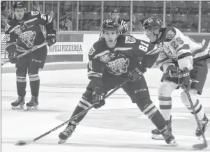  ?? JEREMY FRASER/CAPE BRETON POST ?? Mathias Laferrière of the Cape Breton Screaming Eagles, left, works his way into the offensive zone as Sean Stewart pressures during Quebec Major Junior Hockey League action at Centre 200 on Tuesday. Moncton won the game 4-3.