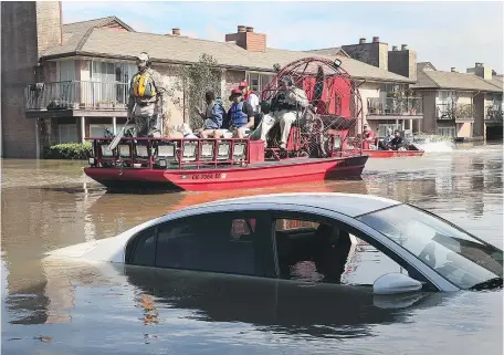  ?? — GETTY IMAGES ?? The floodwater­s were receding in Houston Wednesday and rescue workers and volunteers were travelling in boats rescuing residents trapped by the deluge caused by Hurricane Harvey.