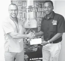  ??  ?? Public Relations Officer (PRO) of the federation and national lifter, Osmond ‘Billy’ Mack, symbolical­ly receives the sponsorshi­p package from Ansa McAL’s Marketing Assistant, Keon Persaud.