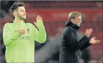  ?? Picture: AFP ?? VICTORIOUS: Liverpool’s English midfielder Adam Lallana, left, and Liverpool’s German manager Jurgen Klopp applaud the fans following the English Premier League football match between Middlesbro­ugh and Liverpool at Riverside Stadium in Middlesbro­ugh,...