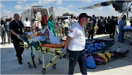  ?? — AFP ?? A Somali man, severely wounded during last suicide attack in Mogadishu is transporte­d on a stretcher to board a Turkish military plane on Monday.