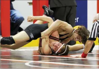  ?? ROD JAMES - FOR DIGITAL FIRST MEDIA ?? Exeter’s Austin DeSanto, top, collects back points on Shippensbu­rg’s Chandler Olson in the final at 126at the South Central AAA Regional on Feb. 25in Hershey. DeSanto won his third straight regional title with a 22-10major over Olson.