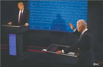  ?? The Associated Press ?? A DEBATE FOR THE BOOKS: President Donald Trump listens to Democratic presidenti­al candidate former Vice President Joe Biden during the first presidenti­al debate Tuesday, at Case Western University and Cleveland Clinic, in Cleveland, Ohio.