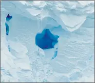  ?? (AP/British Antarctic Survey/David Vaughan) ?? (Left photo) This 2020 photo provided by the British Antarctic Survey shows the Thwaites glacier in Antarctica. Starting Thursday, a team of scientists are sailing to the massive but melting Thwaites glacier, “the place in the world that’s the hardest to get to,” so they can better figure out how much and how fast seas will rise because of global warming eating away at Antarctica’s ice. (Above photo) A hole is visible in the Thwaites glacier in Antarctica.