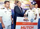  ??  ?? Nilantha Heenitigal­a Director Motor Sports Navy receiving the main sponsorshi­p package from Thirukumar Nadarasa, CEO - Hutchinson Telecommun­ication. Also in the picture, Commodore J.P. Premaratne and Commodore Sunanda Kaluarachc­hi