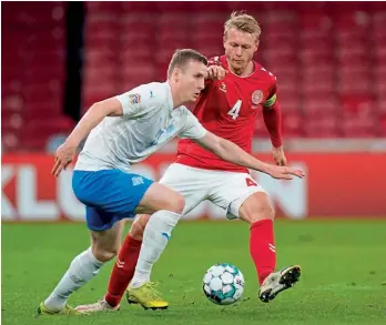  ??  ?? Defender…Kjaer challenges Iceland’s Jon Dadi Bodvarsson