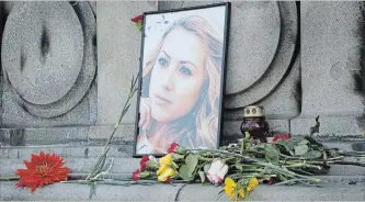  ?? FILIP DVORSKI THE ASSOCIATED PRESS ?? A photo of Viktoria Marinova, a television journalist who was strangled to death on Saturday, is placed on the Liberty Monument in Ruse, Bulgaria, on Wednesday. German police have arrested a suspect in her killing.