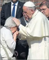  ??  ?? Pope Francis blesses a former camp inmate