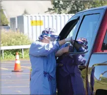  ??  ?? A Community Memorial nurse administer­s a flu shot during the 2020Drive-flu Clinic.
