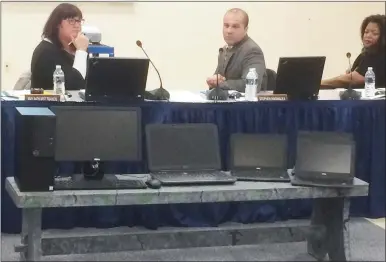  ?? MEDIANEWS GROUP FILE PHOTO ?? From left, Pottstown School Board President Amy Francis, Superinten­dent Stephen Rodriguez and Vice President Katina Bearden listen to a presentati­on last year comparing computer costs. Unlike wealthier districts, Pottstown struggled to provide devices to all students for at-home learning.