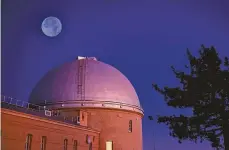  ?? Getty Images / Science Source ?? The moon, seen here above Lick Observator­y in San Jose, will be in near total eclipse this week for the longest duration this century.