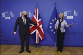  ?? AARON CHOWN — POOL VIA AP ?? Britain’s Prime Minister Boris Johnson is welcomed for a dinner with European Commission President Ursula von der Leyen, right, in Brussels, Belgium, Wednesday.