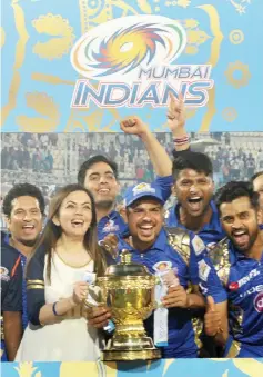  ?? - AFP photo ?? Mumbai Indians players and support staff are joined by team owner Nita Ambani (2L) and former player Sachin Tendulkar (L) as they celebrate their victory against Rising Pune Supergiant after the 2017 Indian Premier League (IPL) Twenty20 final cricket match between Mumbai Indians and Rising Pune Supergiant at The Rajiv Gandhi Internatio­nal Cricket Stadium in Hyderabad.