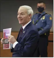  ?? (Arkansas Democrat-Gazette/Staton Breidentha­l) ?? Gov. Asa Hutchinson holds the final report from the Task Force to Advance the State of Law Enforcemen­t in Arkansas as he speaks Thursday in Little Rock during a news conference with members of the task force.