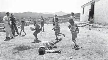  ??  ?? ‘Weekend drunks. Farm northeast of Oudtshoorn. The adults were inside drinking rotgut wine. The kids were outside playing rugby. A drunk stumbled out of the house and demanded to play as well. He lasted about five minutes and passed out dead drunk. The kids left him alone. It did not seem to bother them. They have seen plenty of drunks before. They just continued the game and played on and around the dead drunk man. 2003’