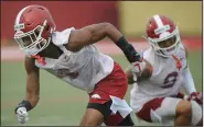  ?? (NWA Democrat-Gazette/Andy Shupe) ?? Arkansas defensive backs Jarques McClellion (left) and Greg Brooks Jr. run through a drill during last year’s fall practice. Football players have asked Arkansas Athletic Director Hunter Yurachek for any kind of decision before the start of fall camp on whether they’ll play this fall.