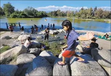  ?? Allen J. Schaben Los Angeles Times ?? CHILDREN play at the Whittier Narrows Recreation Area. Officials with the U.S. Army Corps of Engineers say that the 60-year-old Whittier Narrows Dam could fail in the event of a very large, very rare storm.