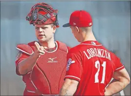  ?? [ROSS D. FRANKLIN/THE ASSOCIATED PRESS] ?? Catcher Devin Mesoraco, left, talks with pitcher Michael Lorenzen after a throwing session at the Reds spring training facility in Goodyear, Ariz.