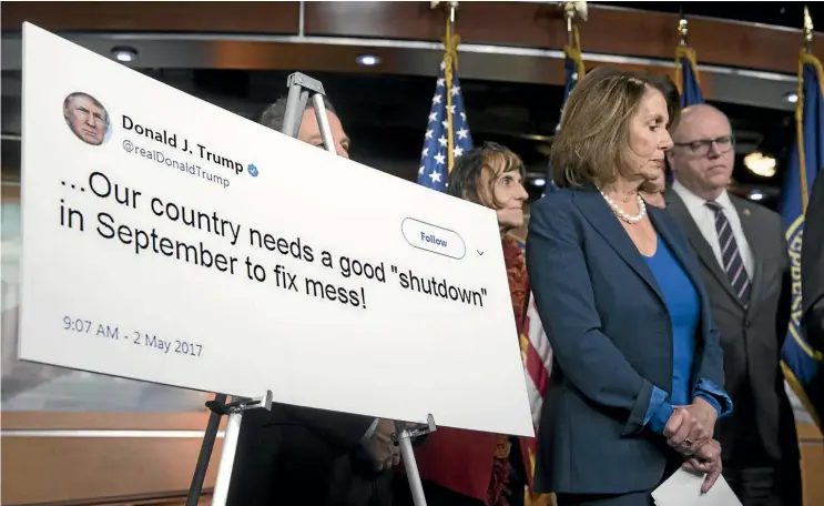  ??  ?? House Minority Leader Nancy Pelosi, flanked by fellow Democrats Rosa DeLauro and Joe Crowley, stands beside a poster of a 2017 tweet by US President Donald Trump appearing to support a government shutdown, during a news conference on Capitol Hill in...