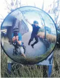  ?? PHOTO: K GARDNER ?? In a bubble but not . . . Danny and Nathan Gardner take a photo of their reflection in a traffic mirror near their home at Burkes, Dunedin.