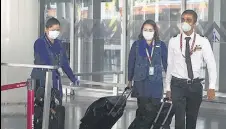  ?? SAMIR JANA/HT PHOTO ?? Air India crew members exit Netaji Subhas Chandra Bose Internatio­nal Airport at Kolkata on May 18.