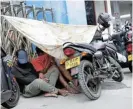  ?? /Reuters ?? Tanking
economy: People wait under a temporary tent in a queue after receiving tokens to buy petrol amid a fuel shortage in Colombo, Sri Lanka.