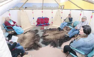  ?? GAVIN YOUNG ?? Three elders — from left, Harriet Heavy Runner, Peter Weasel Moccasin and Leroy Heavy Runner — sit with school councillor Cara Black Water, right, in Kainai High School’s Elders in Residence program lodge.