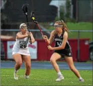  ?? PETE BANNAN - DIGITAL FIRST MEDIA ?? Interboro’s Sam Shemeluk, left, defends against Phoenixvil­le’s Allison Bonshock in the opening round of the PIAA District 1 Class 2A girls lacrosse playoffs Wednesday evening. Phoenixvil­le went on to a 17-7 victory.