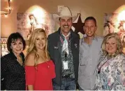  ??  ?? Service to Houston’s annual rodeo is a year-round commitment for Tony Burt (center) of RE/MAX Associates Northeast. Shown (L to R) are his business partner Robin Culet; RE/MAX office co-owners Candace and Rex Wall; and his wife, Mary Jo Burt.