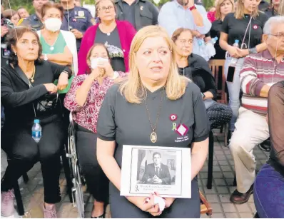  ?? AP ?? Attorney General Sandra Quinonez, holding an image of the late anti-drug prosecutor Marcelo Pecci, attends a meeting to demand justice over his murder, in Asuncion, Paragua