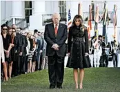  ?? WIN MCNAMEE/ ?? President Donald Trump, wife Melania and the White House staff observe a moment of silence on Monday.