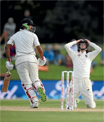  ?? PHOTO: GETTY IMAGES ?? Ish Sodhi’s stoic resistance reduced England captain Joe Root, right, to his knees as New Zealand held on for an heroic draw in the second test.