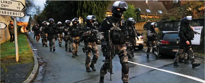  ??  ?? Show of force: Heavily armed soldiers search villages in northern France where the Al Qaeda killers were thought to have fled yesterday